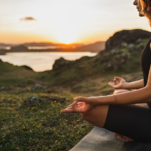 Healthy Lifestyle and Yoga Concept. Close-up hands. Woman do yoga outdoors at sunrise